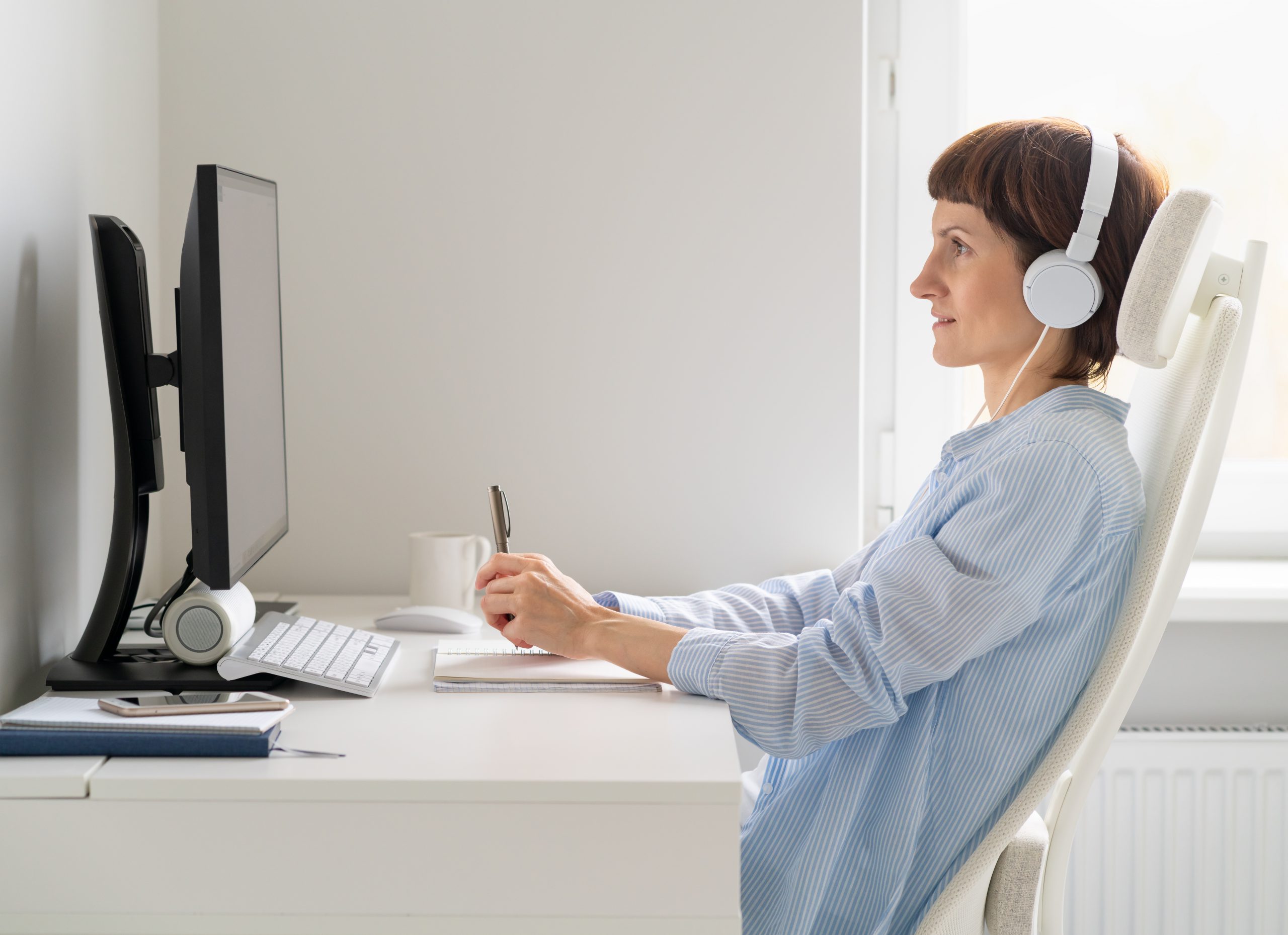 side-view-of-middle-aged-woman-working-remotely-fr-MN5XGDS